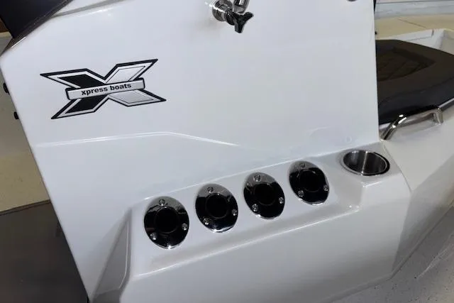 Slide: The Image of 2026 Xpress H20B Bay boat detail with logo and rod holders. - 15