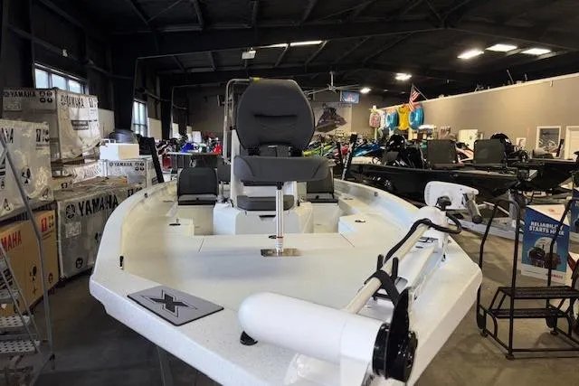 Slide: The Image of 2026 Xpress H20B Bay boat displayed in a showroom with Yamaha equipment. - 2