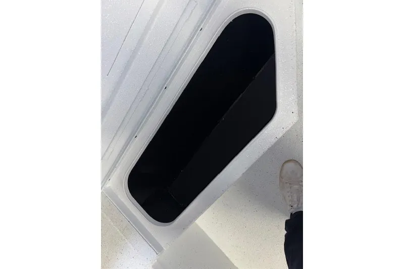 Slide: The Image of Open storage compartment on 2026 Xpress H20B Bay boat deck. - 21