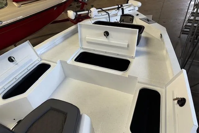 Slide: The Image of 2026 Xpress H20B Bay boat with open storage compartments and trolling motor. - 22