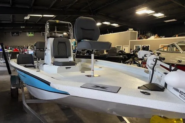 Slide: The Image of 2026 Xpress H20B Bay boat in showroom, featuring sleek design and modern seating. - 3