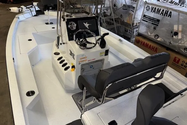 Slide: The Image of 2026 Xpress H20B Bay boat interior with steering console and seating, displayed indoors. - 30
