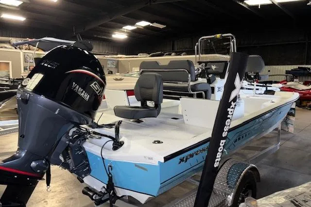 Slide: The Image of 2026 Xpress H20B Bay boat with Yamaha engine in showroom. - 7