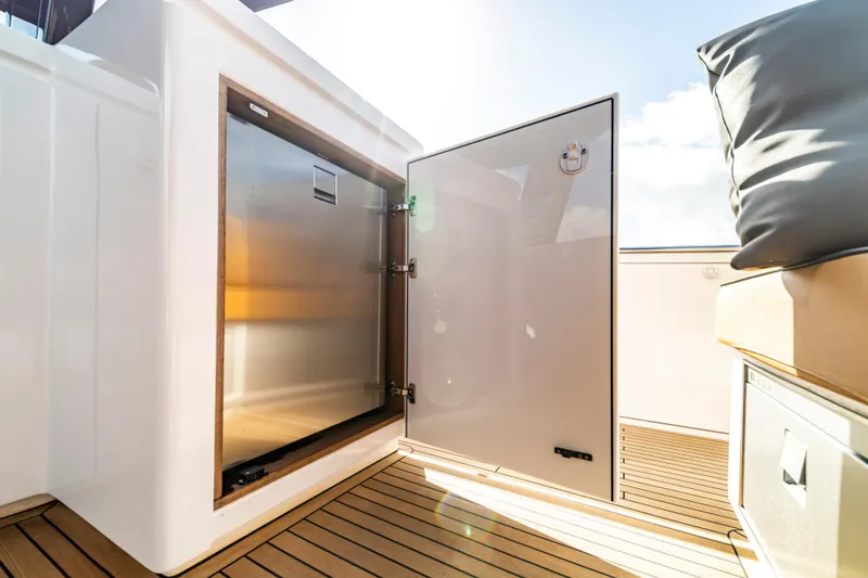 Slide: The Image of 2023 Pardo Yachts 50, open storage compartment on teak deck, sunlight reflecting. - 12