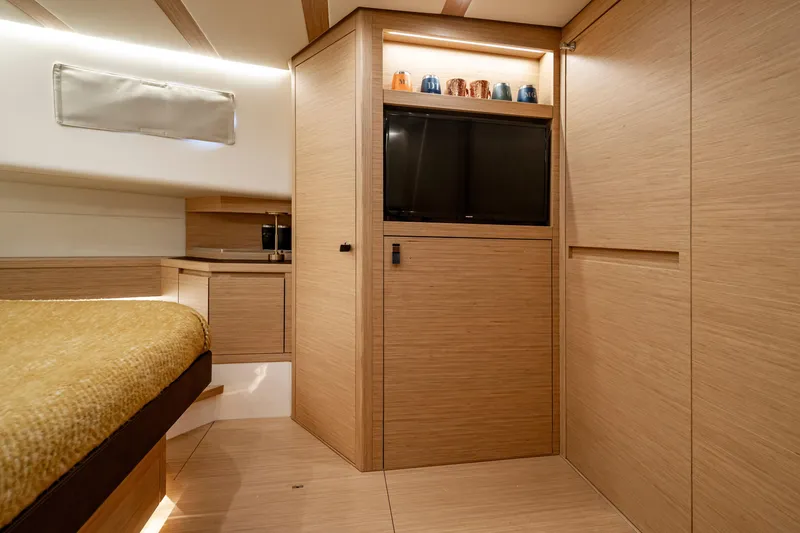 Slide: The Image of Luxurious interior of 2023 Pardo Yachts 50, featuring modern wood finishes and cozy bedding. - 27