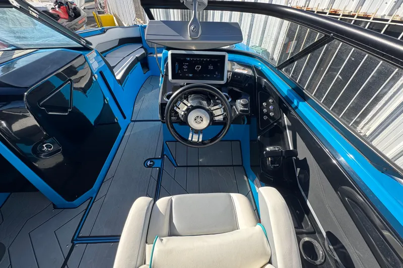 Slide: The Image of 2022 Yamaha Boats 255XD cockpit with modern steering and dashboard controls. - 16