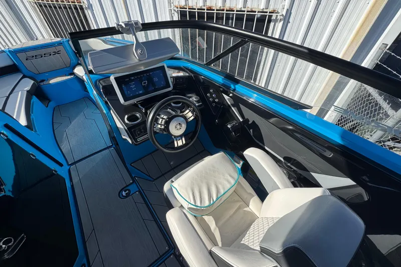 Slide: The Image of Interior of 2022 Yamaha Boats 255XD, featuring modern dashboard and steering wheel. - 17
