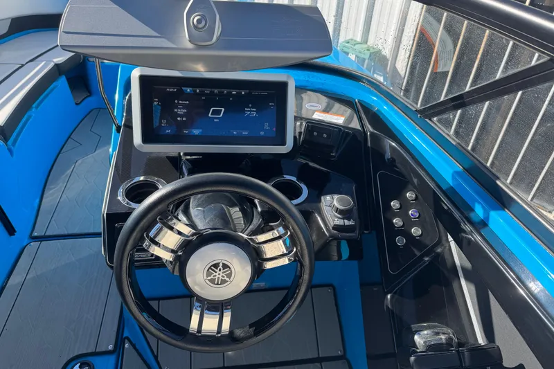 Slide: The Image of 2022 Yamaha Boats 255XD dashboard with steering wheel and touchscreen display. - 18