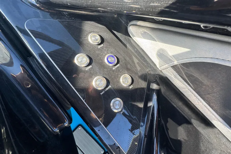 Slide: The Image of Control panel of 2022 Yamaha Boats 255XD with various switches and buttons. - 24