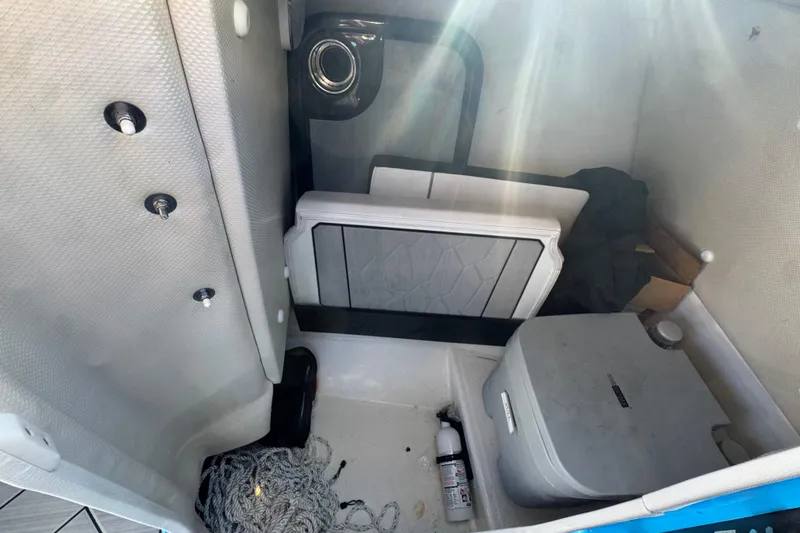Slide: The Image of Interior storage compartment of 2022 Yamaha Boats 255XD with various boating accessories. - 29