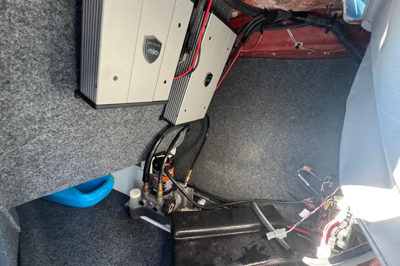 Slide: The Image of Interior view of a 2022 Yamaha Boats 255XD, showcasing electronic components and wiring. - 33