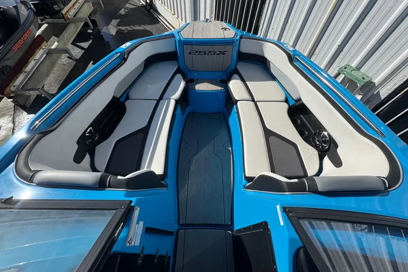 Slide: The Image of 2022 Yamaha Boats 255XD interior with blue and white seating, showcasing modern design. - 34