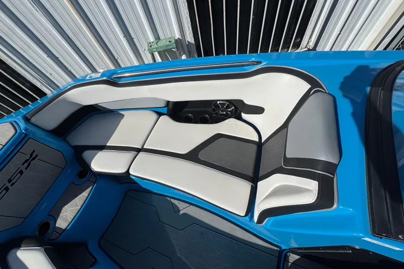 Slide: The Image of 2022 Yamaha Boats 255XD interior with blue and white seating, featuring cup holders. - 35