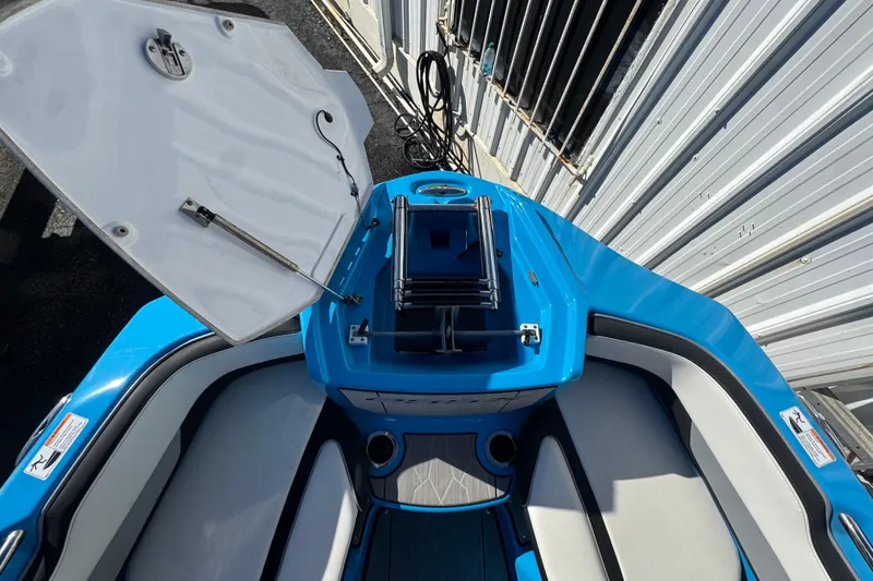 Slide: The Image of 2022 Yamaha Boats 255XD interior with open storage compartment and seating. - 41