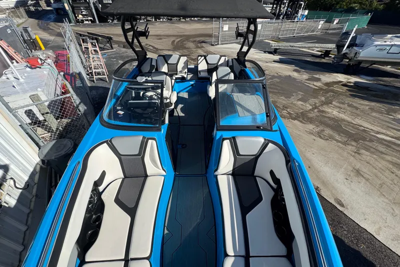 Slide: The Image of 2022 Yamaha Boats 255XD, blue and white interior, docked at a marina. - 43