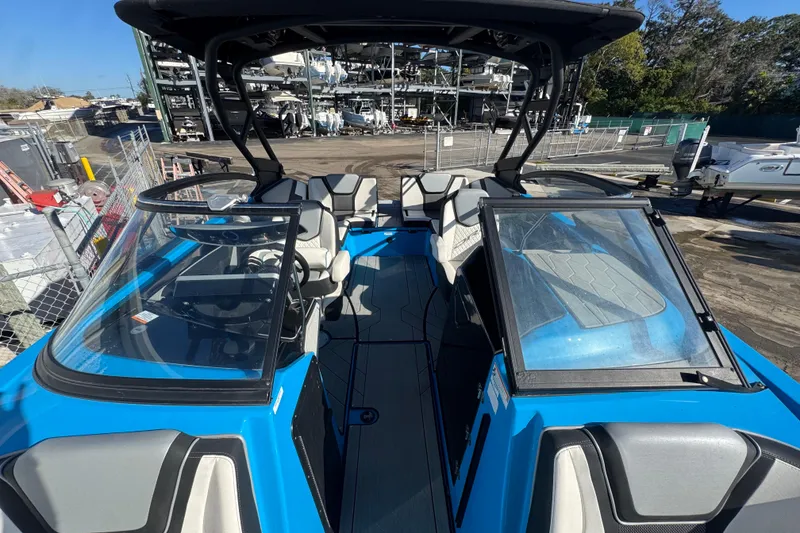 Slide: The Image of 2022 Yamaha Boats 255XD interior with blue exterior, featuring modern seating and dashboard. - 44