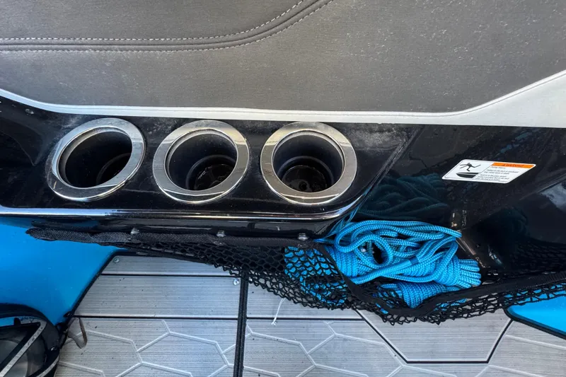 Slide: The Image of Cup holders and storage net with blue rope on a 2022 Yamaha Boats 255XD. - 49