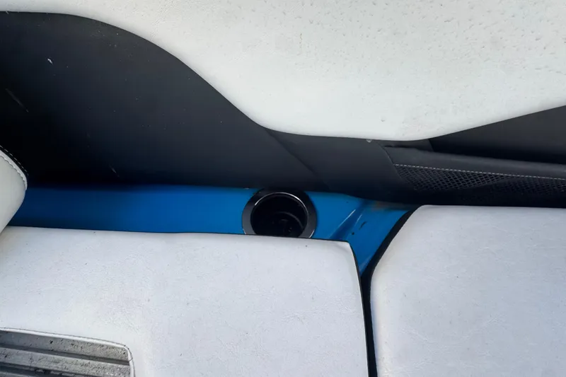 Slide: The Image of Interior of 2022 Yamaha Boats 255XD, featuring white seating and a cup holder. - 62