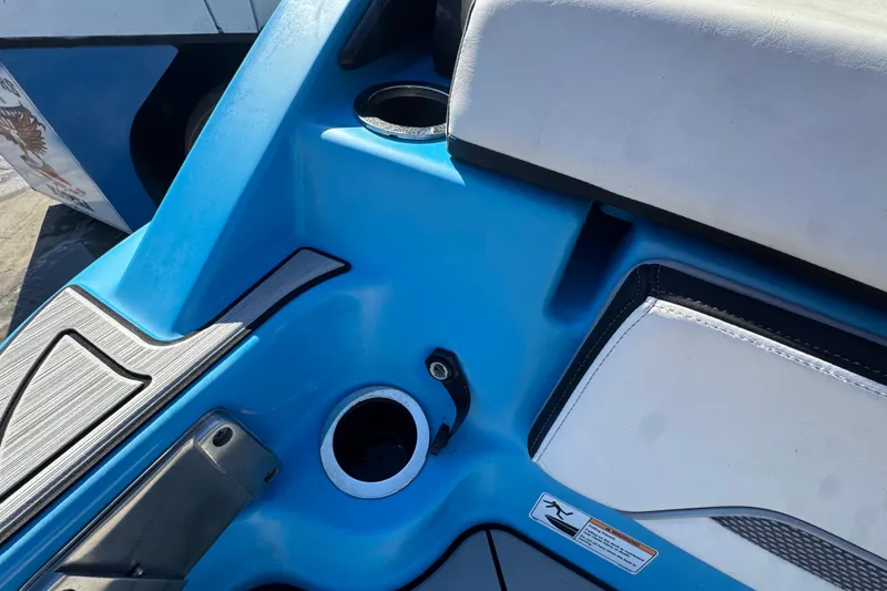 Slide: The Image of 2022 Yamaha Boats 255XD interior detail with blue and white seating. - 81