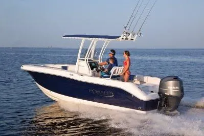 The Image of 2026 Robalo R200 Center Console boat cruising on open water with passengers. - 1
