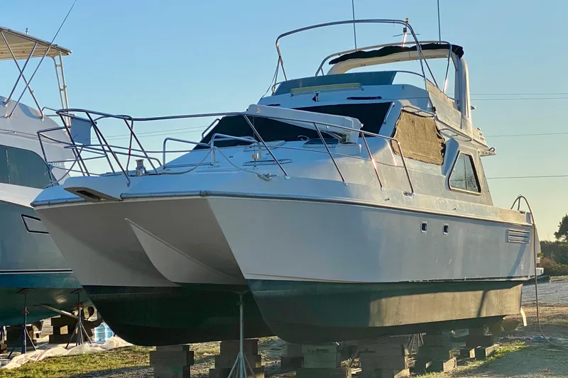 The Image of 2001 SportsCat 44 boat on dry dock, showcasing sleek design and sturdy build. - 0