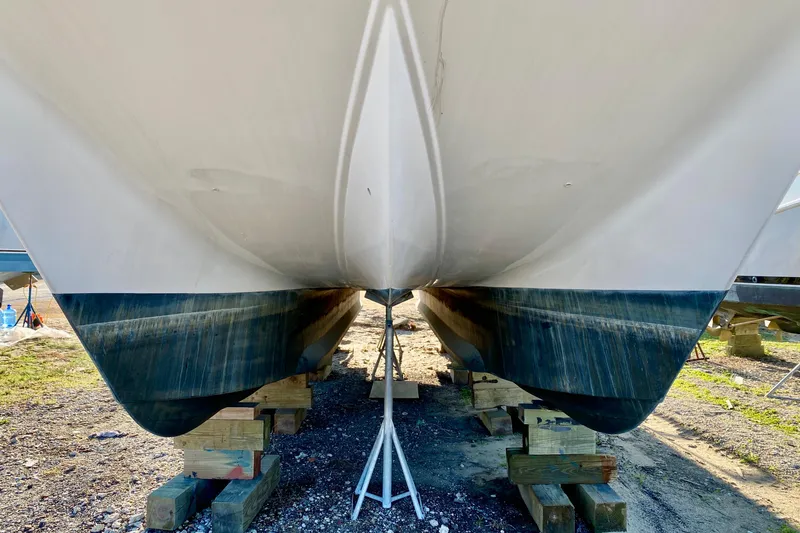 Slide: The Image of Catamaran hull of 2001 SportsCat 44 on wooden supports, viewed from below. - 10