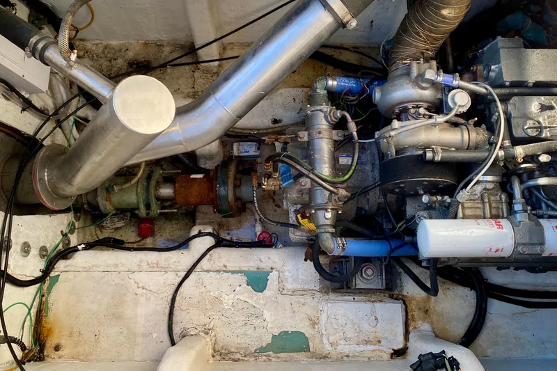 Slide: The Image of Engine compartment of a 2001 SportsCat 44, showcasing mechanical components and piping. - 101