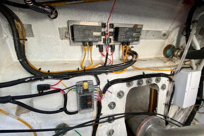Slide: The Image of Electrical wiring and components inside a 2001 SportsCat 44 boat engine compartment. - 102