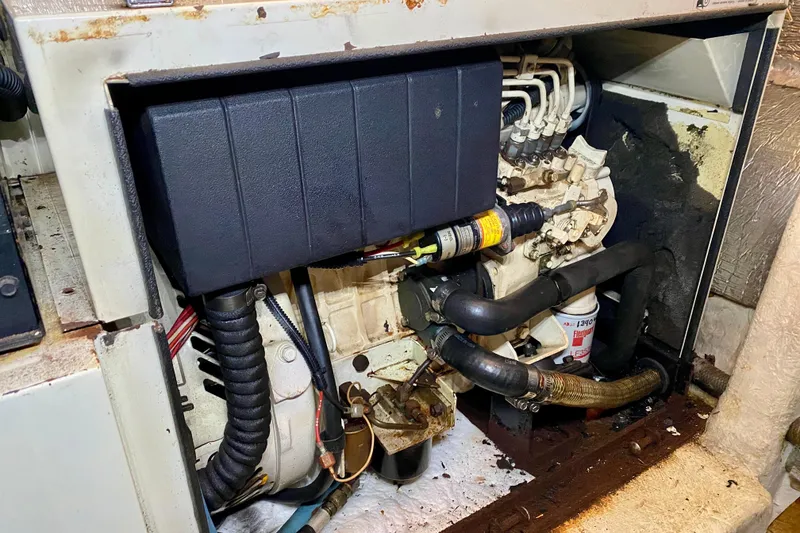 Slide: The Image of Engine compartment of a 2001 SportsCat 44, showing mechanical components and wiring. - 111