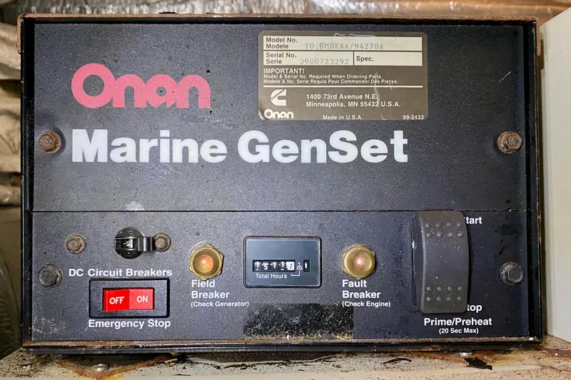 Slide: The Image of Onan Marine GenSet control panel with emergency stop and circuit breakers, SportsCat 44, 2001 model. - 112