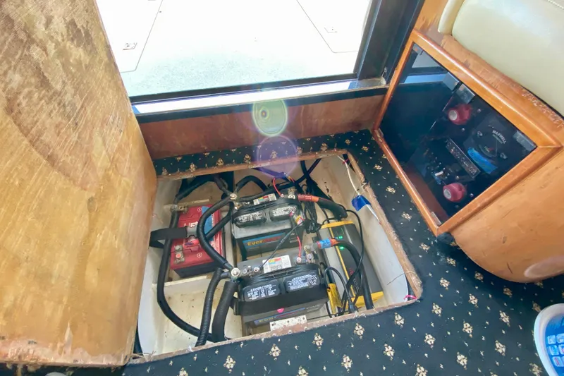 Slide: The Image of Battery compartment of a 2001 SportsCat 44, featuring multiple batteries and wiring. - 115