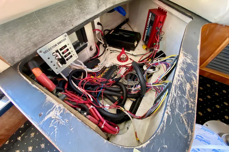 Slide: The Image of Electrical wiring and selector switch inside a 2001 SportsCat 44 boat. - 116
