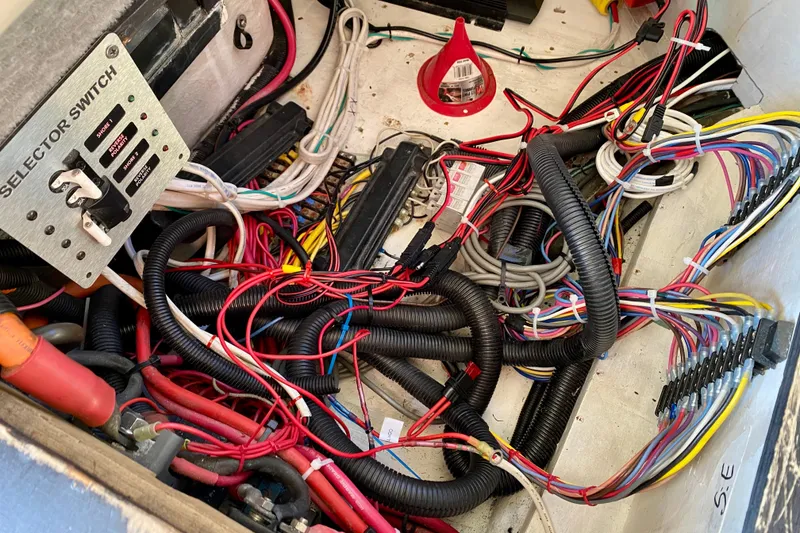 Slide: The Image of Tangled wiring and selector switch in a 2001 SportsCat 44 boat. - 117