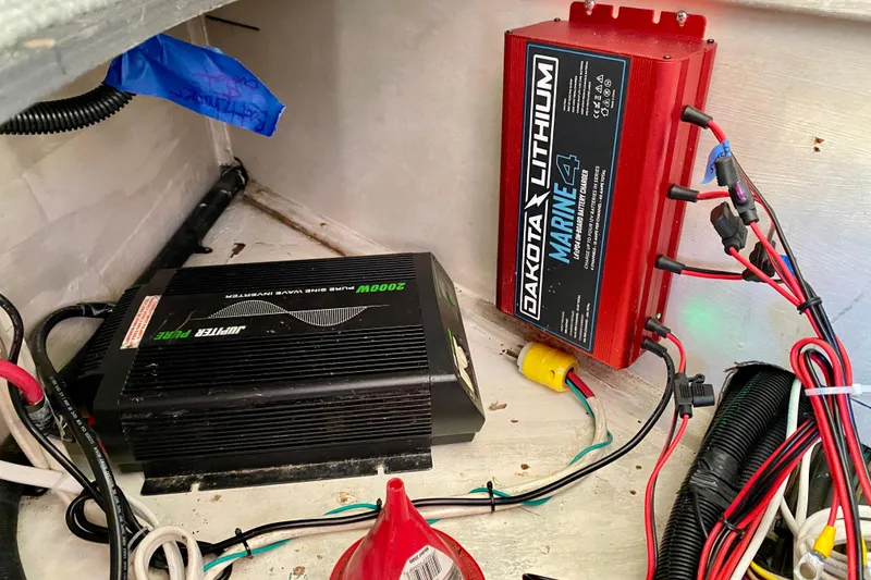 Slide: The Image of Electrical setup in a 2001 SportsCat 44, featuring a Dakota Lithium Marine battery charger. - 118