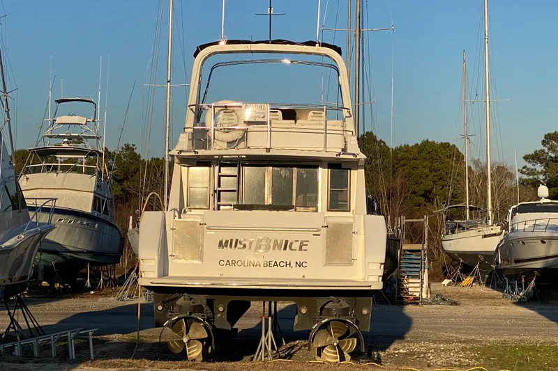 Slide: The Image of Boat named "Must Be Nice" in a marina, surrounded by other vessels. - 126