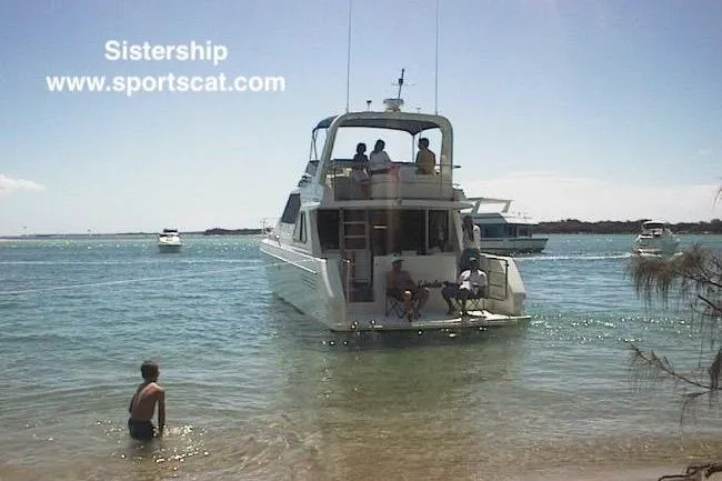 Slide: The Image of Luxury SportsCat 44 yacht anchored near shore, people enjoying sunny day, 2001 model. - 132