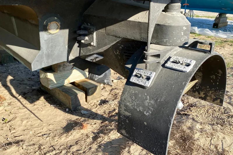 Slide: The Image of Rear view of a 2001 SportsCat 44 boat propeller and rudder on wooden blocks. - 14