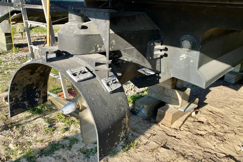 Slide: The Image of Close-up of a 2001 SportsCat 44 boat propeller and rudder on wooden blocks. - 15