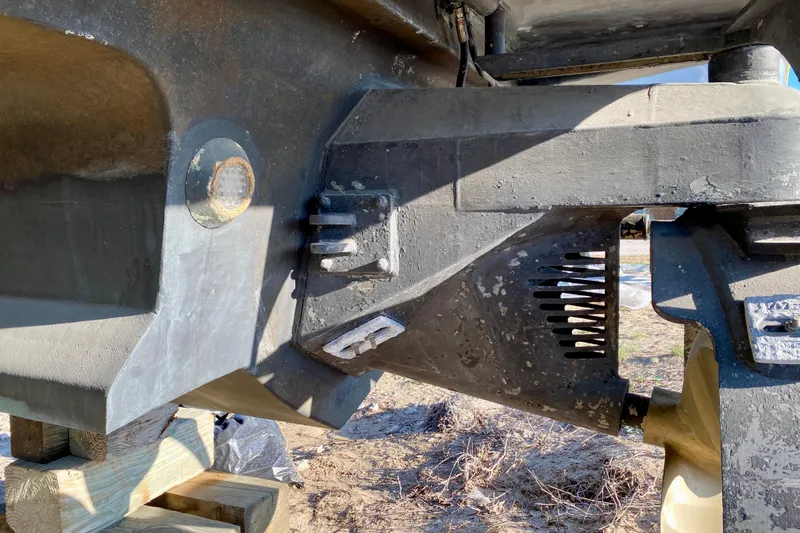 Slide: The Image of Close-up of a 2001 SportsCat 44 boat hull detail, showing structural components and weathered surface. - 16