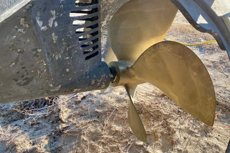 Slide: The Image of Close-up of a SportsCat 44 boat propeller, 2001 model, on sandy ground. - 17
