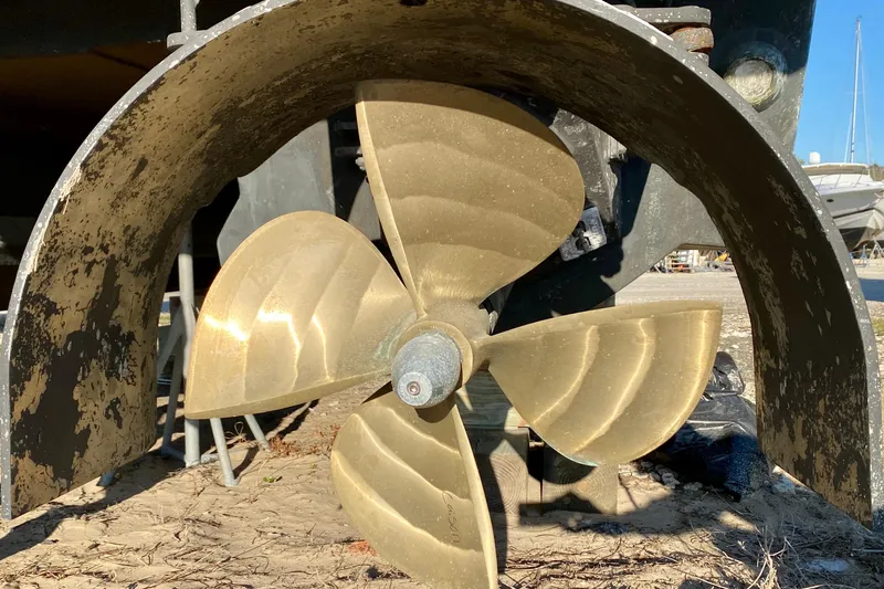Slide: The Image of Close-up of a SportsCat 44 boat propeller, 2001 model, on a sandy surface. - 20