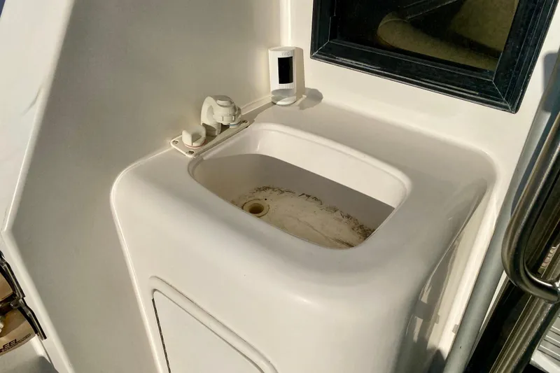Slide: The Image of White sink on a SportsCat 44 boat, 2001 model, with faucet and window. - 22