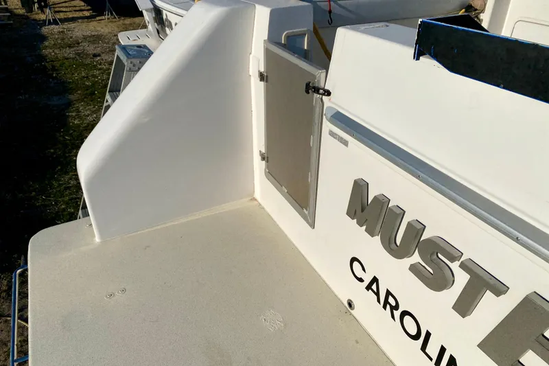 Slide: The Image of 2001 SportsCat 44 boat deck with open hatch and visible lettering. - 26