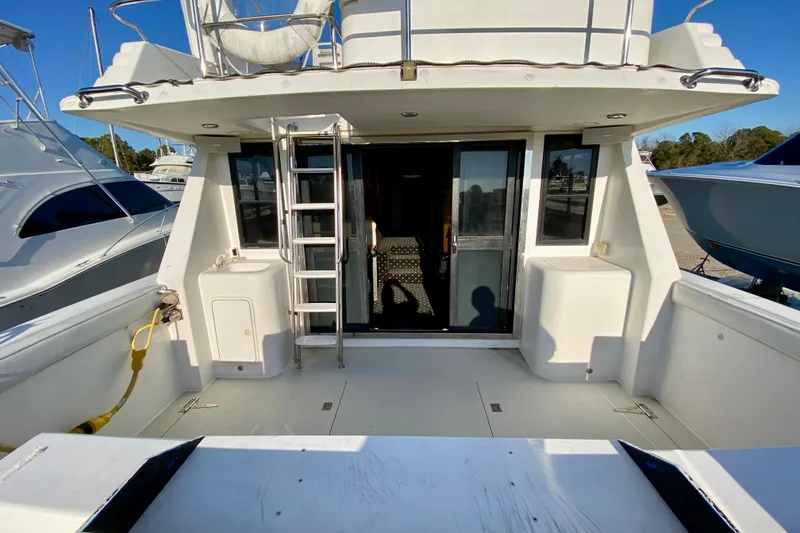 Slide: The Image of Rear view of 2001 SportsCat 44 boat with ladder and sliding glass door. - 27