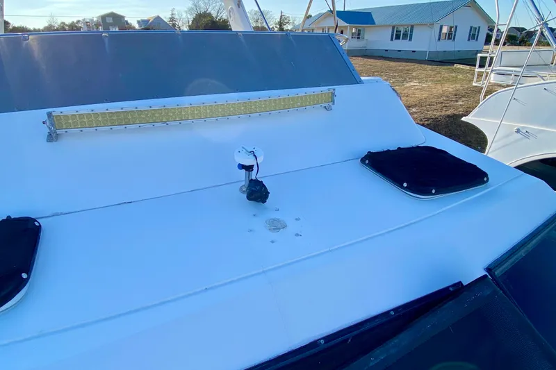 Slide: The Image of 2001 SportsCat 44 boat deck with light bar and hatches. - 33