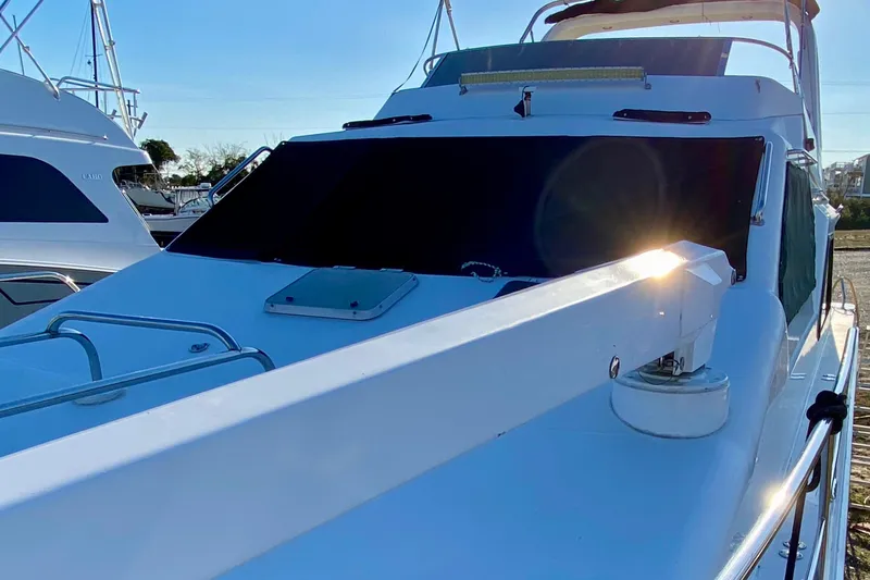 Slide: The Image of 2001 SportsCat 44 yacht with sunlit deck and sleek design. - 38