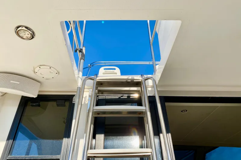 Slide: The Image of Stainless steel ladder on SportsCat 44 yacht, 2001 model, leading to open hatch under clear blue sky. - 42