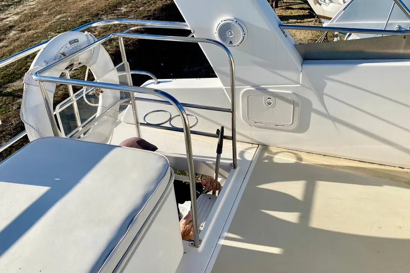 Slide: The Image of 2001 SportsCat 44 boat deck with railing and life preserver. - 44