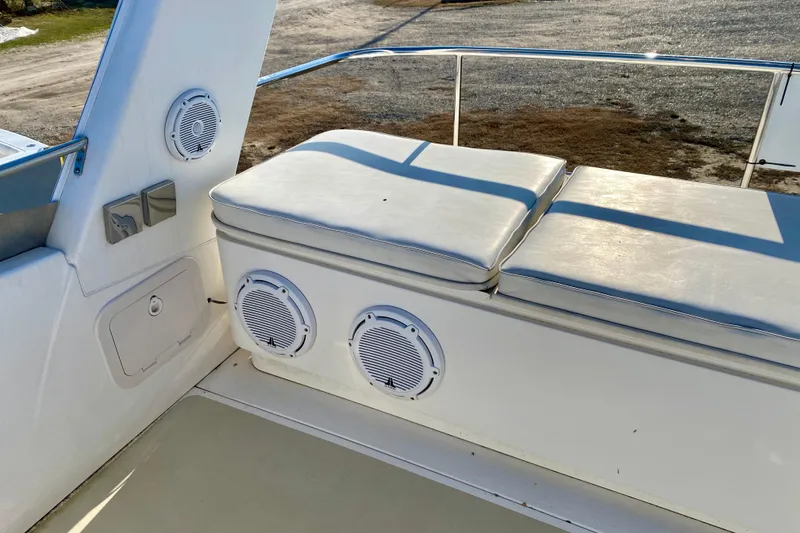 Slide: The Image of White cushioned seating on 2001 SportsCat 44 boat with built-in speakers. - 46