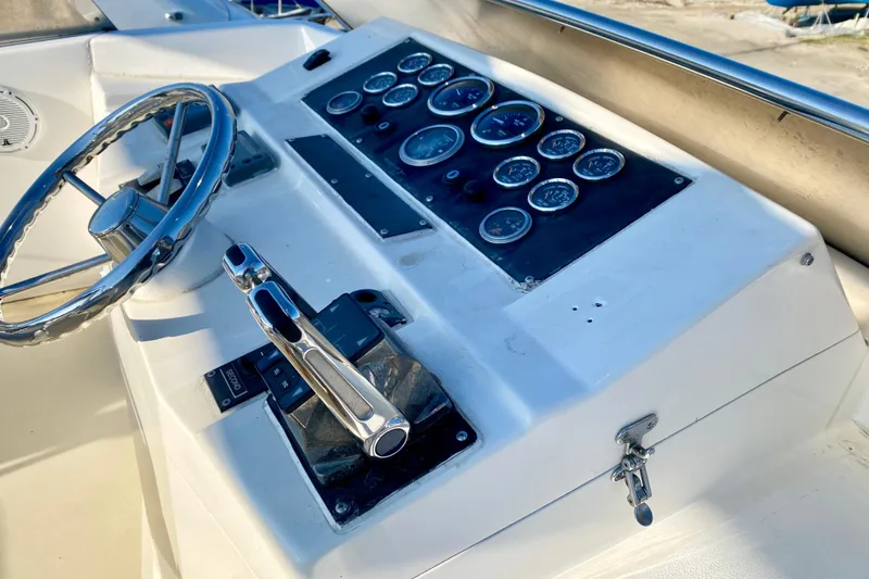 Slide: The Image of Control panel of a 2001 SportsCat 44 boat with steering wheel and gauges. - 47